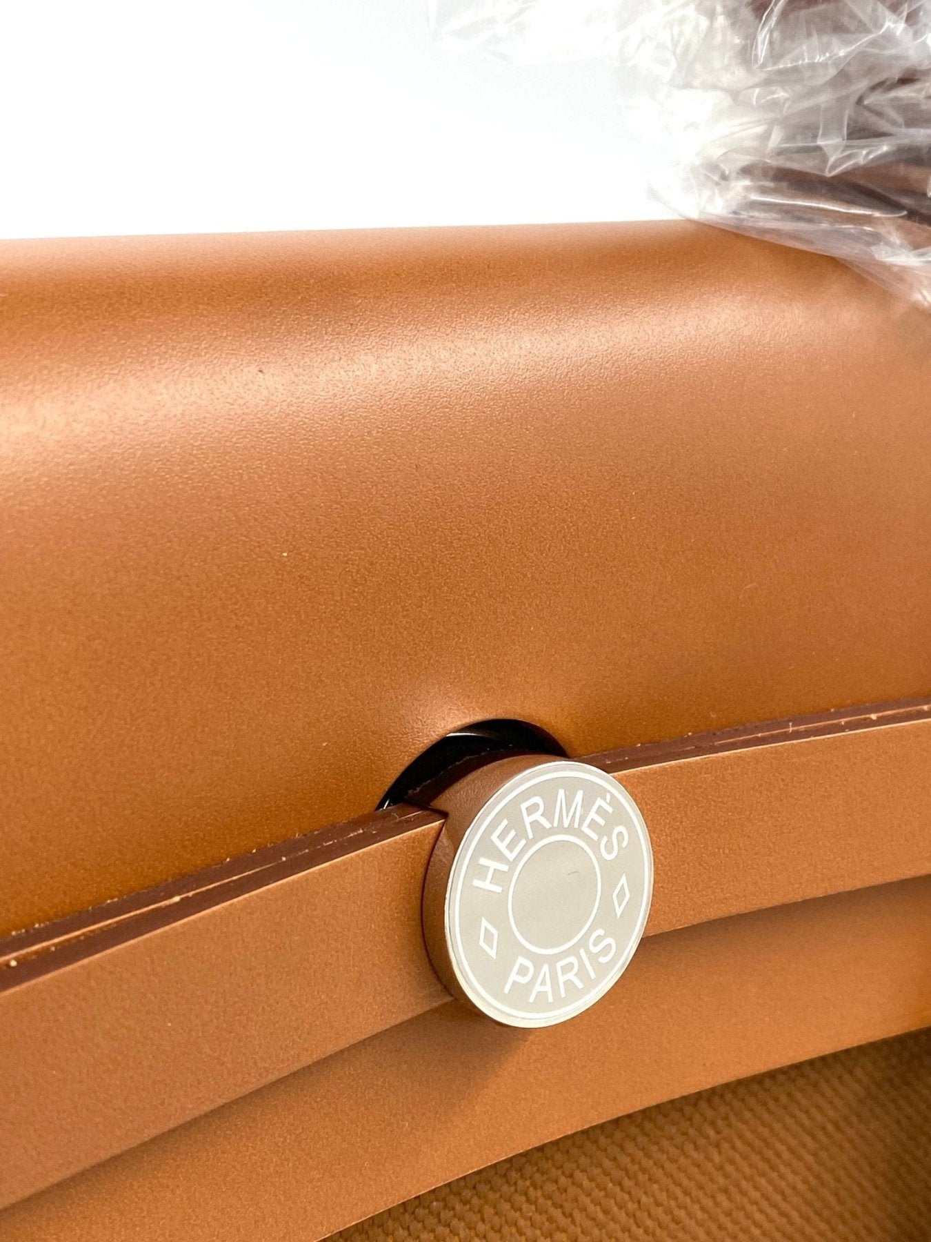 Hermes Herbag Messenger 39 in cognacfarbenem Leder mit silbernem Logodetail, teilweise in Schutzfolie verpackt