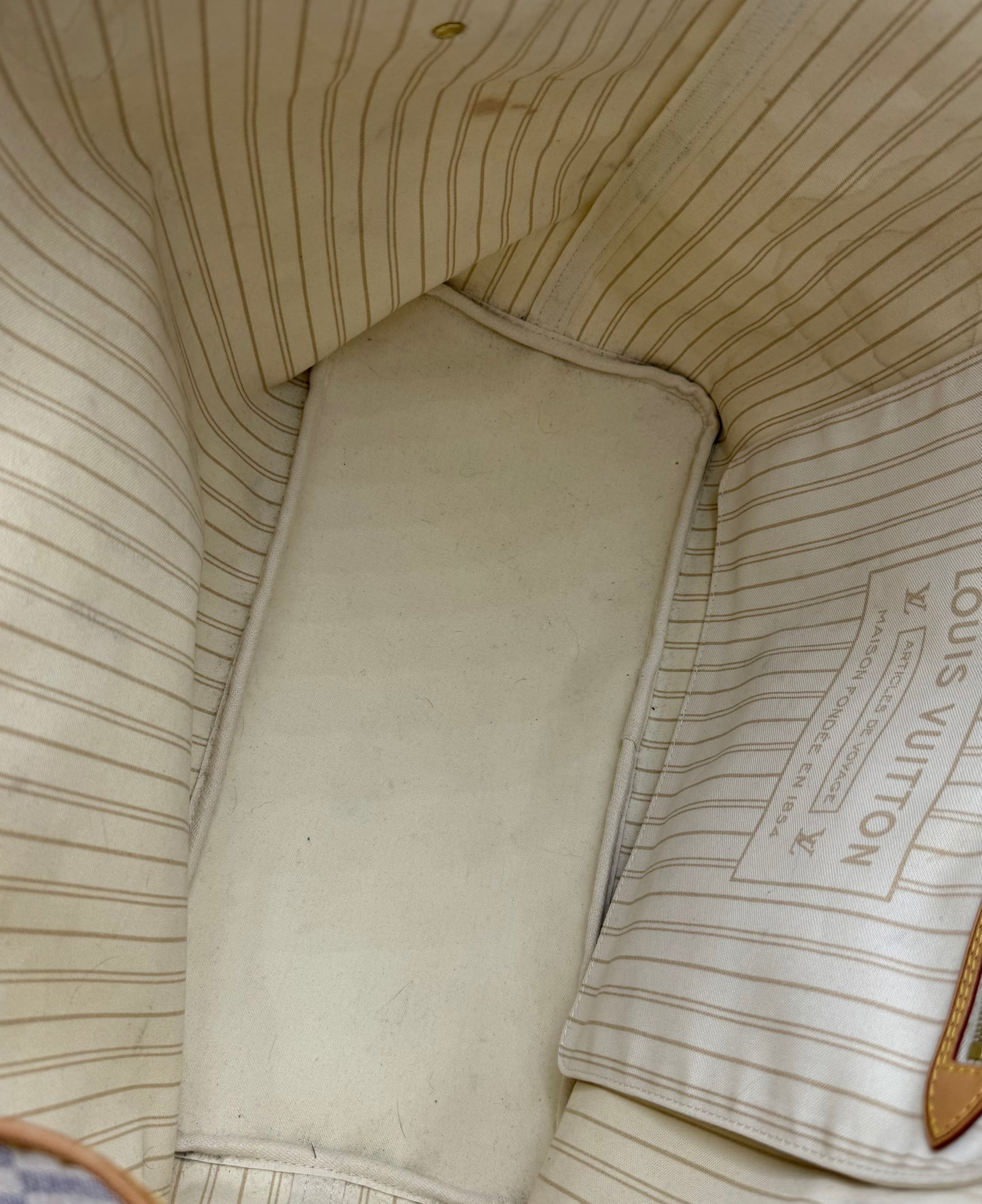 Innenansicht der Louis Vuitton Neverfull GM Damier Azur mit gestreiftem Innenfutter und Reißverschlussfach, guter Zustand.