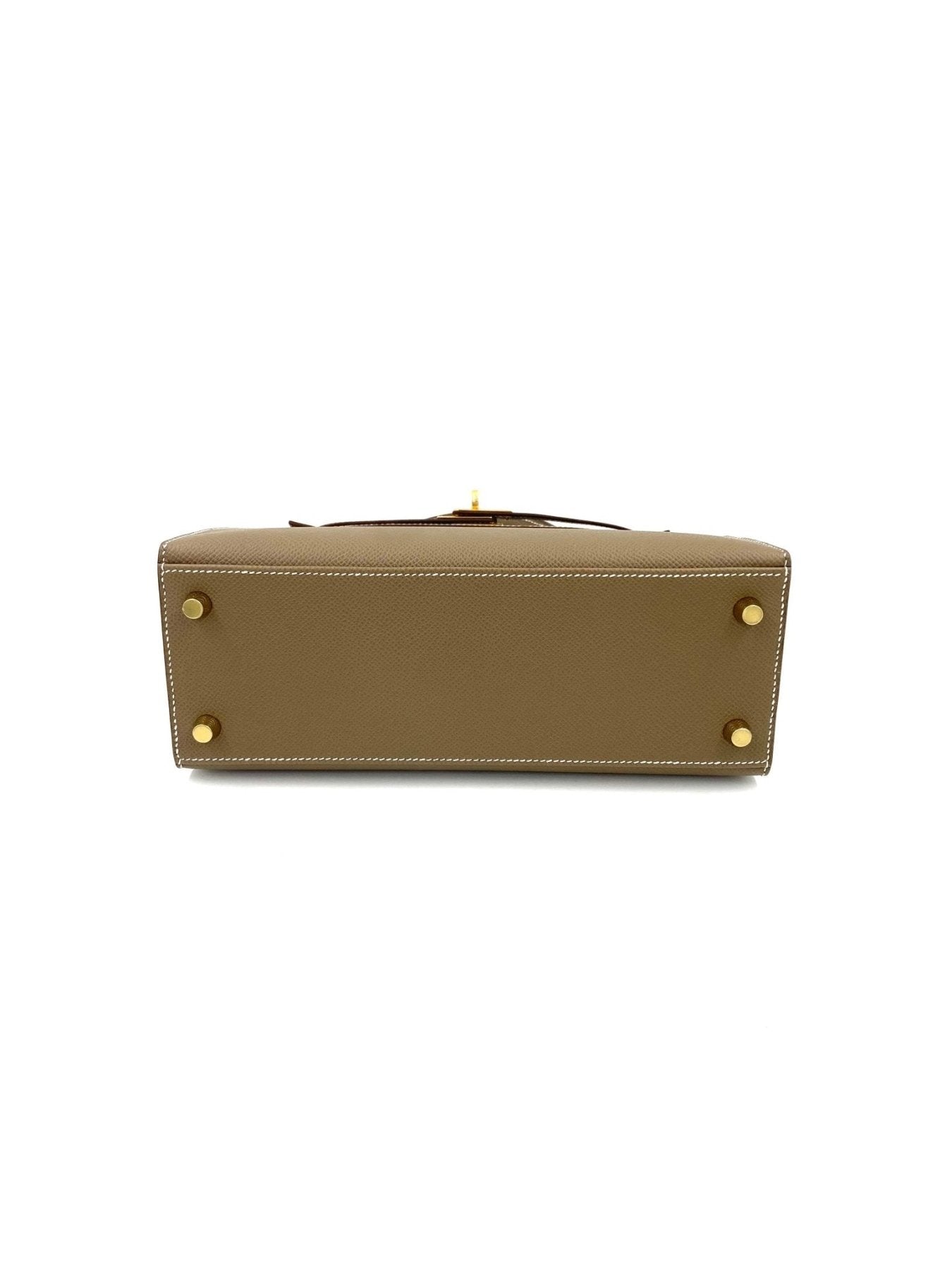 Hermes Kelly 25 Epsom Sellier Etoupe Tasche von unten fotografiert, zeigt goldfarbene Fussnieten auf beigefarbenem Leder