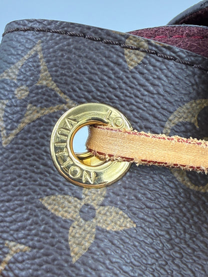 Detailansicht eines Zugbands mit goldfarbenem Ösenring bei der LOUIS VUITTON Montsouris MM Monogram Canvas Tasche