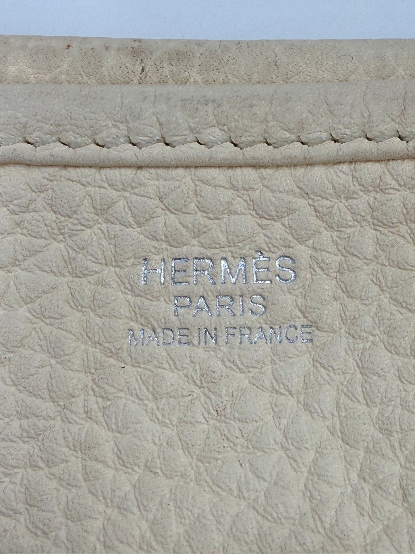 Detailaufnahme des Labels der HERMÈS Evelyne 29 Nata Clemence PHW aus hochwertigem beigem Leder.